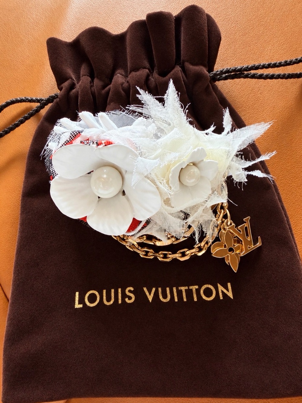 Louis Vuitton White Floral Charm Chain Brooch with Gold-Tone LV Logo.